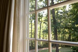 A window with a view of trees and a yard photo