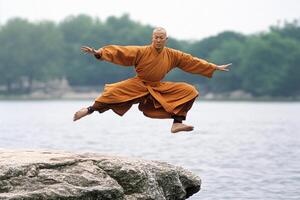 A man in a monk outfit jumping on a rock photo