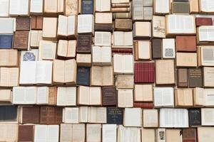 A large pile of old books on a table photo
