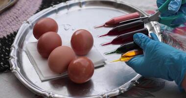 Watch as colorful paint brings Easter eggs to life through each step of the egg painting process. Discover tips and tricks for vibrant designs and unique Easter eggs. video