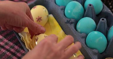 Creating blue yellow Easter eggs through the fun step of egg painting process using bright colors and decorative stickers. Perfect for family activities and celebrations. video
