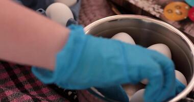 Eggs are prepared for boiling in the step of egg painting process. Get inspired to decorate your Easter eggs with vibrant colors and fun patterns. video