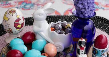 Learn the joy of decorating Easter eggs with vibrant colors. Enjoy creating a charming centerpiece featuring beautifully painted eggs. video