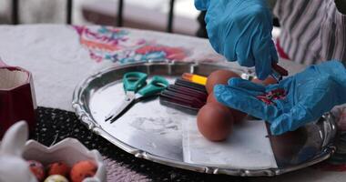 Explore the step of egg painting process as vibrant colors come alive on Easter eggs. Join this festive activity filled with creativity and joy during the Easter celebration. video