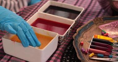 Experience the joy of egg coloring as hands dip into colorful dyes for Easter eggs. Watch the step of egg painting process unfold with various techniques and beautiful hues. video