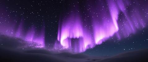 The aurora borealis is seen in the sky above a snowy mountain photo