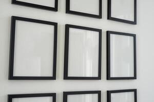 Blank frame for photo mockup hanging on the wall