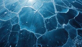 close up of the cracked ice background with a bluish gray tint and transparent areas. The network of cracks creates a unique pattern that highlights the frosty beauty of winter nature. photo