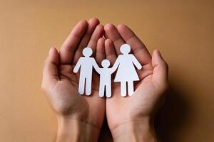 Hands Holding Paper Cutout Family Representing Connection And Support photo