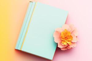A book and a flower on a pastel background photo