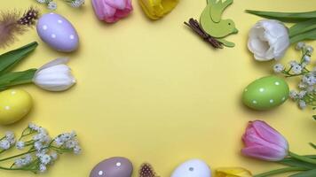 Colorful easter eggs and tulips rotate, creating a festive frame video