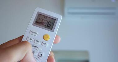 hand turns air conditioner on, embarking journey cooler ambiance. Pressing buttons initiates temperature-lowering journey, transforming warmth chill, inviting adventure. journey technology. video
