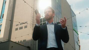 Caucasian middle-aged businessman adult business man male guy entrepreneur angry irritated trying call with mobile phone failure connection error Wi-Fi lost broken smartphone bad signal in sunny city video
