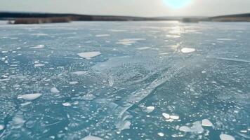 Ice on the surface of a lake with the sun shining video