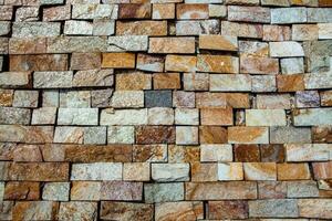 Close up of a wall made of natural stones. Abstract background. photo