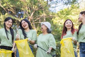 Teamwork Concepts, Group of Volunteers Engaged in Cleanup Activity, Eco Volunteers Collecting Plastic Waste in Park, Teamwork for a Greener Planet, Female Volunteers Picking Up Trash photo