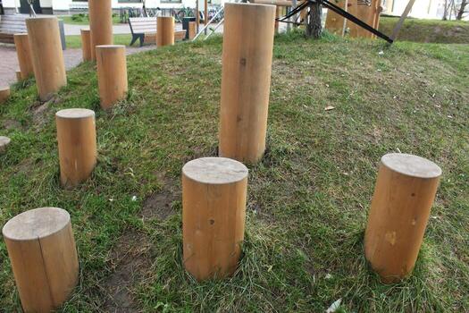 Wooden posts of different heights on the playground photo
