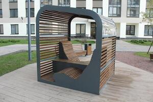 Modern gazebo bench with table in the yard photo