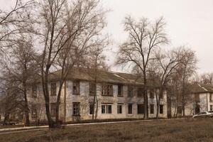 A general view of the street with two storey houses with several apartments for demolition in the spring. Dilapidated housing without tenants photo
