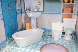 Miniature bathroom display features modern amenities and vibrant decor in a colorful design, showcasing a tub, sink, and toilet in a playful arrangement ideal for a dollhouse photo