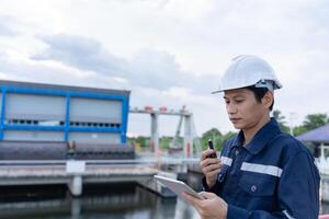 maintenance and inspector Maintenance engineers are using walky talky to inform the results of inspection of buildings and structures. Irrigation engineers are exploring sluice systems photo