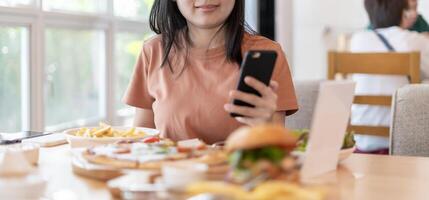 Woman use smartphone to scan QR code to pay in cafe restaurant with a digital payment without cash. Choose menu and order accumulate discount. E wallet, technology pay online, credit card, bank app photo