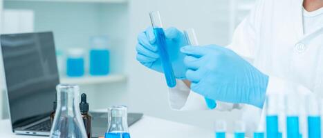 Scientist analyze biochemical samples in advanced scientific laboratory. Research and development staff use dropper mix microbiological developmental of perfume, Biotechnology research in science lab photo
