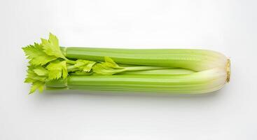 Whole celery stalk with leafy greens isolated on white background with realistic shadow. Organic and fresh celery vegetable for vegan, vegetarian, and detox food themes photo