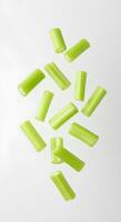 Fresh crunchy celery stick isolated on white background with subtle shadow. Healthy and nutrient-rich vegetable perfect for smoothies, salads, and low-calorie meal ideas photo