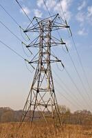 Power transmission pole in a field photo