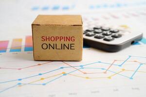 Online shopping, Shopping cart box on calculator, import export, finance com photo