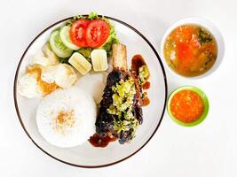 Rice and grilled ribs isolated on white background photo