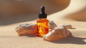 A bottle of face serum with amber liquid, lying on top of rocks. 3 photo