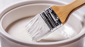 A paint brush with soft bristles and a fine texture is placed in a bucket. 2 photo