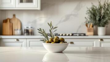 A traditional kitchen with a bowl of olives and an olive branch on the countertop. 1 photo