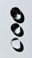 Different sizes and shapes of transparent droplets, symbolizing the diversity in beauty products. 4 photo