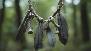 The necklace with weathered bones and dull gray feathers against a forest background. 16 photo