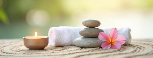 Spa stones and a candle on a wooden table photo
