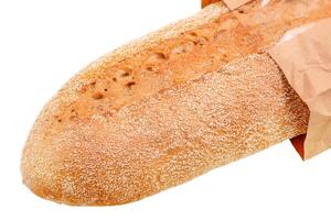 Buckwheat baguette isolated on a white background. Bread in a paper bag. photo