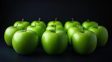 Shiny green apples arranged artfully on a dark surface creating a striking visual display for healthy snacking photo