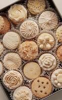 A variety of intricately designed cupcakes fills a tray, each adorned with unique patterns of frosting and sprinkle photo