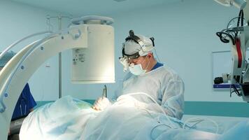 surgeons perform an operation and look through a mobile microscope 7 video