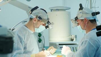 surgeons perform an operation and look through a mobile microscope 6 video