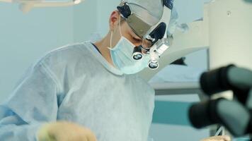 surgeons perform an operation and look through a microscope 6 video