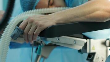 the patient lies on the operating table with a sensor on his finger video
