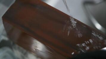 hand sharpens a knife under using stone and water video