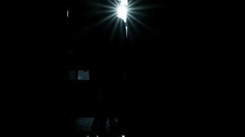 Man walks along a dark long corridor. Abandoned building, dark corridor, dark silhouette of a man, light in the doorway, ruins, broken windows, rust, unfinished 2 video