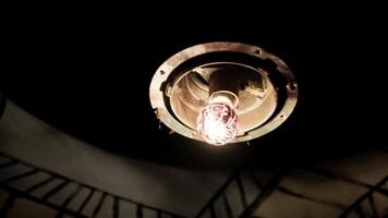 the abstract light turns on in an old shabby light bulb in an abandoned room. Darkness video
