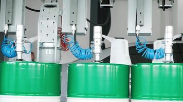 Motor oil in barrels with pump indoors with copy space. Store of lube. Product for bottling close up. Maintenance. Warehouse inside. Background of automotive shop. Auto service. Change of oil. 5 video