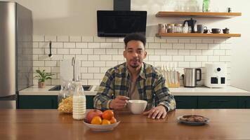 African American man enjoying breakfast, looking at the camera with a happy expression, ending with a satisfied smile video